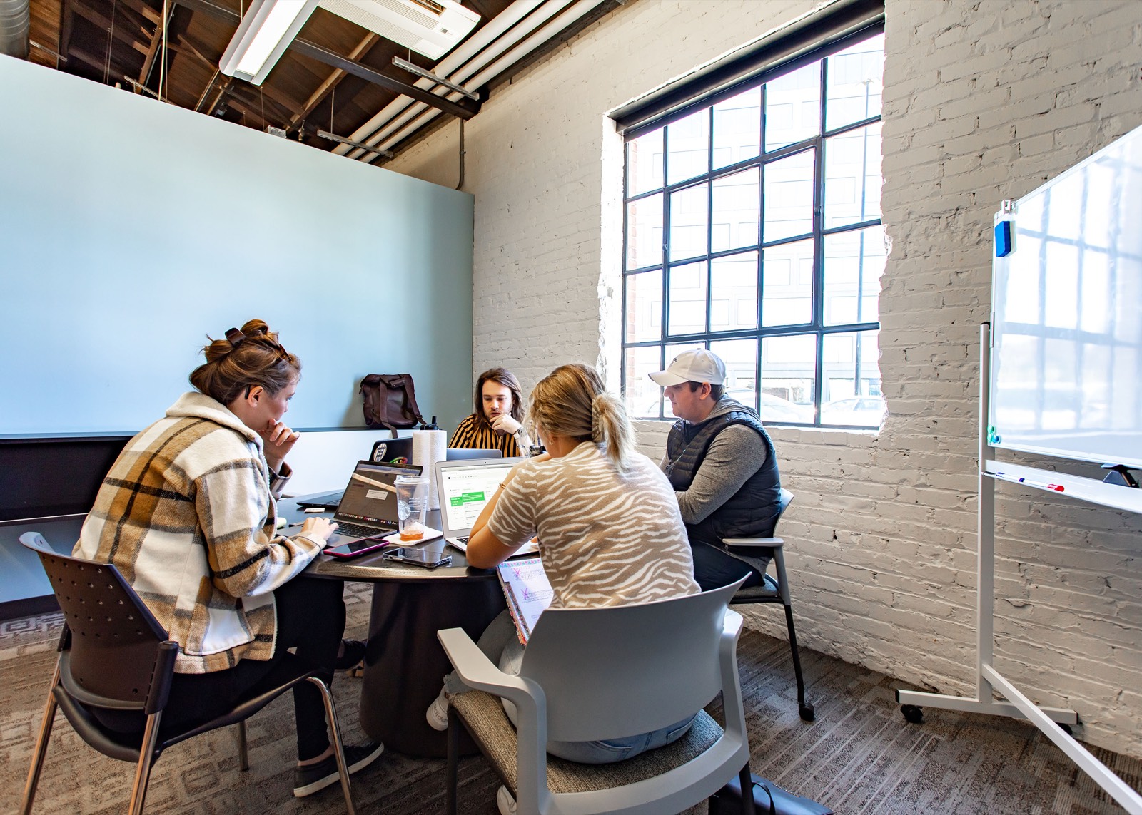 Four founders working around a table in a conference room at the EC.